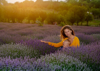 Mother and her baby in the lavender field .