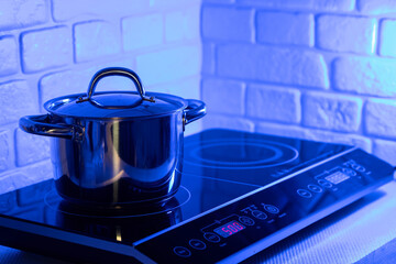 Metal Pot on induction hob in modern kitchen