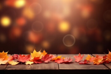 Naklejka na ściany i meble Autumn leaves on wooden table and blurred background