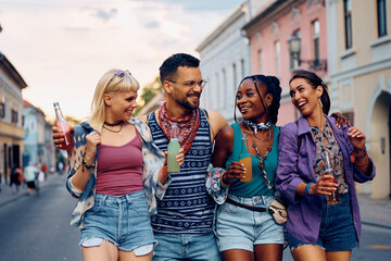 Young happy people have fun while going to open air music concert during summer.