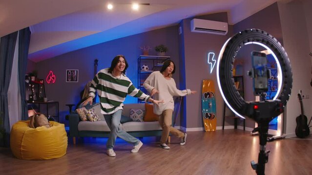 Asian bloggers dancers record videos. Incredible dance performance from Asian guys that fills social media with hashtags, forces to like every post. Dance masterpiece attracts lot of followers, likes
