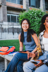 Portrait of smiling college student girl looking at camera. She is with her friends.