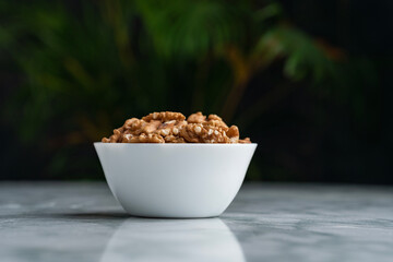 Top view of walnut with bowl and copy space for text