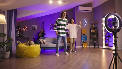 Guys videobloggers shoot dance cover. Dance cover of K-pop choreography to Korean music. Energetic and talented Asian teen guys embody their passion for dancing in impressive video for social media. - Powered by Adobe