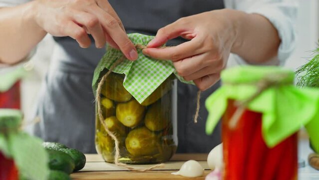 Organic, home kitchen hostess Cooking vegetables with marinade and brine in a home kitchen. farmer housewife combines ingredients cooking copyright fermented vegetables, canned tomatoes