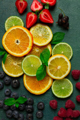 Fototapeta na wymiar mix of fruits and berries,set, assortment, sliced citrus fruits, raspberries, blueberries, mint leaves, strawberries, red currants, food background, fruit wallpaper,