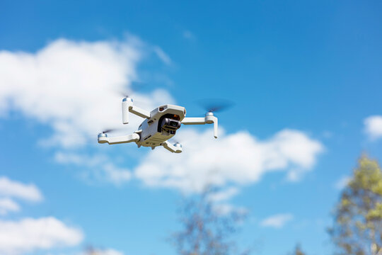 drone flying in silhouette against the blue sky, copter on a blurred background in the sunlight, slow motion