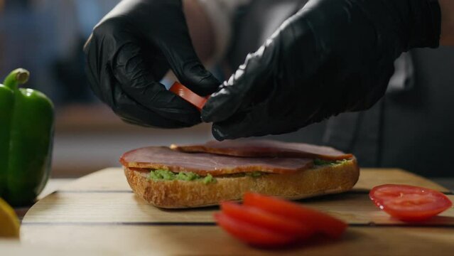Cooking, chef baker prepares concentrated addition of red tomato sauce in a specialty diner. Trailing Shot Fast Food Chef Preparing Customers Orders Showing His Food Making Skills, Cheeseburger