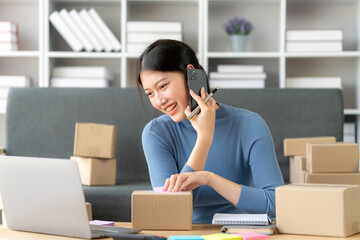 Portrait of Starting small businesses SME owners female entrepreneurs working on receipt box and check online orders to prepare to pack the boxes, sell to customers, SME business ideas online.