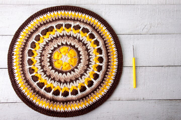 Crocheted yellow-brown round mandala