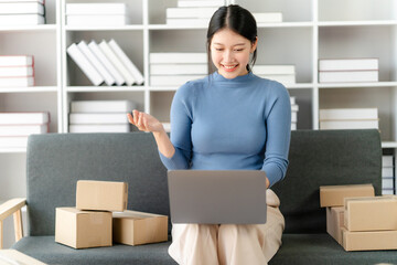 Portrait of Starting small businesses SME owners female entrepreneurs working on receipt box and check online orders to prepare to pack the boxes, sell to customers, SME business ideas online.