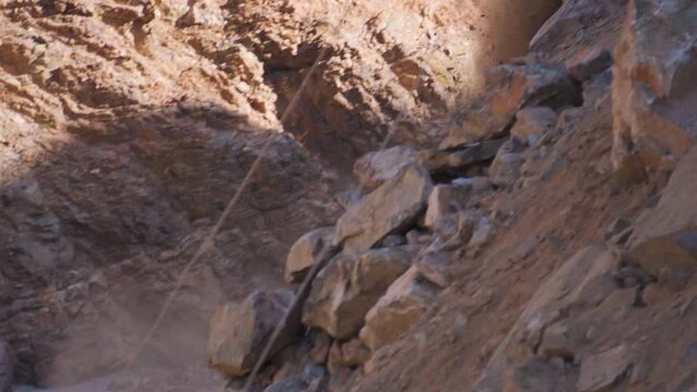 Slow motion shot of Rocks falling from mountain due to landslide in Manali, Himachal Pradesh, India. Natural disaster in mountains during monsoon. Calamity in the Himalayas.