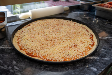 Margarita pizza on tray in pizza shop.