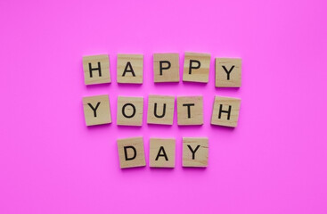 August 12, International Youth Day, minimalistic banner with the inscription in wooden letters Happy Youth Day