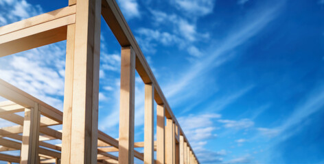 wooden house frame against blue sky background. banner with copy space