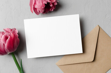 Wedding invitation card mockup with envelope and pink tulip flowers