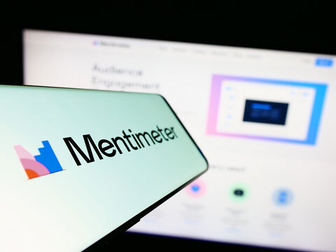 Stuttgart, Germany - 07-09-2023: Cellphone with logo of presentation software company Mentimeter on screen in front of business website. Focus on center-left of phone display.
