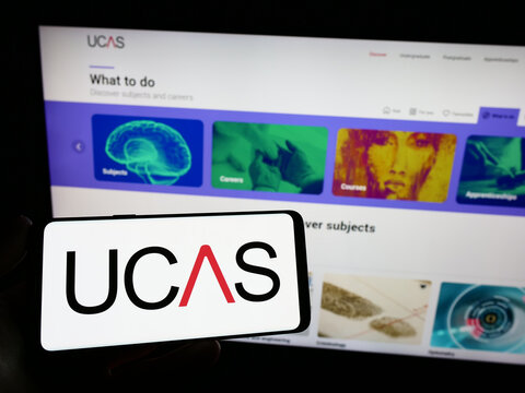 Stuttgart, Germany - 07-09-2023: Person holding smartphone with logo of Universities and Colleges Admissions Service (UCAS) on screen in front of website. Focus on phone display.
