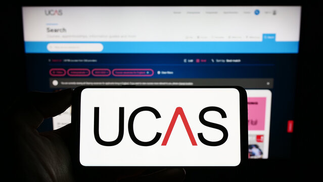 Stuttgart, Germany - 07-09-2023: Person holding cellphone with logo of Universities and Colleges Admissions Service (UCAS) on screen in front of web page. Focus on phone display.