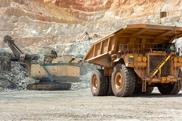 Electric rope shovel and dump truck at a copper mine in Peru - obrazy, fototapety, plakaty