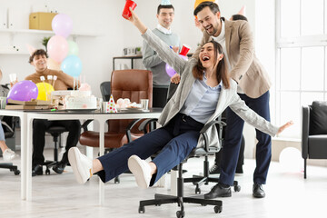 Group of business people at birthday party in office