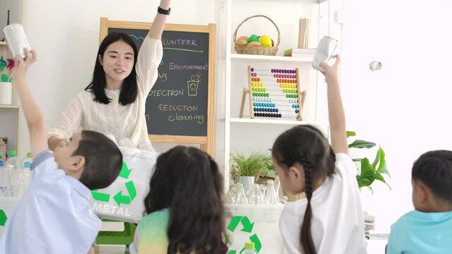 Asian female teacher teaches students about recycling. zero waste, ecological friendly and saving the environment concept.