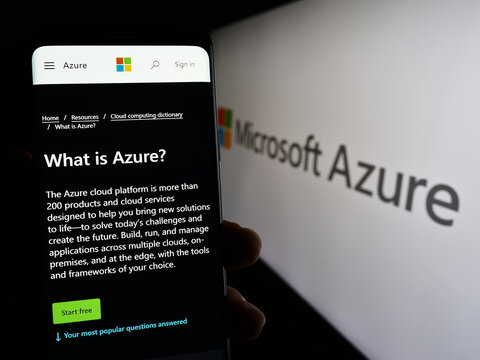Stuttgart, Germany - 07-11-2023: Person holding cellphone with web page of cloud computing platform Microsoft Azure on screen in front of logo. Focus on center of phone display.