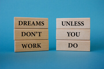 Dreams don't work unless you do text. Wooden blocks with words Dreams don't work unless you do....