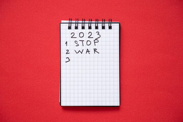 The notepad contains the year 2023 and the numbering of the numbers 123 and the text stop the war, which lies on a red background, plans