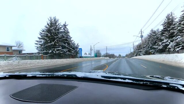Driving through the snowy streets in winter, driver's perspective, timewarp, 4K