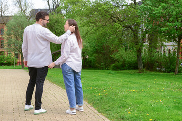 Fototapeta premium Beautiful happy couple walking in park on spring day