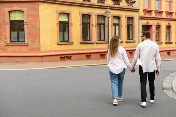 Fototapeta na wymiar Beautiful happy couple walking in city on spring day