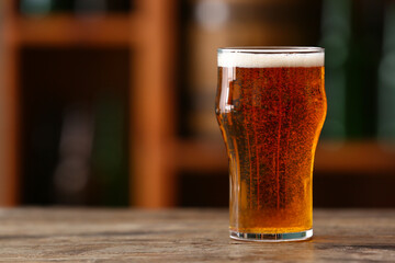 Glass of beer on table in bar. Oktoberfest celebration