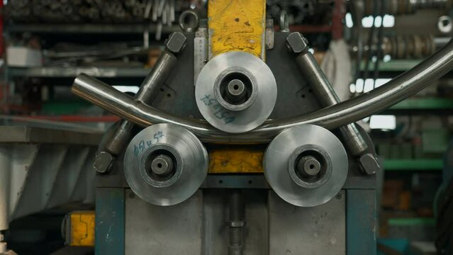 Industrial machine for cold metal pipe bending at industrial hall at manufacturing plant. Creative. Heavy industry concept.