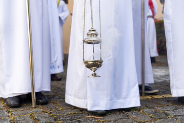Catholic seminarians participate in the Palm Sunday mass with incense.
