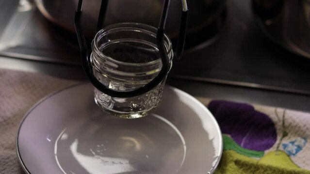 Canning process sequence filling jars with raspberry jam