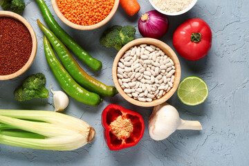 Different fresh vegetables and cereals on blue background