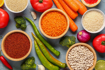 Different fresh vegetables and cereals on blue background