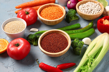 Different fresh vegetables and cereals on blue background