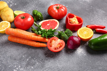 Different fresh vegetables on grey background