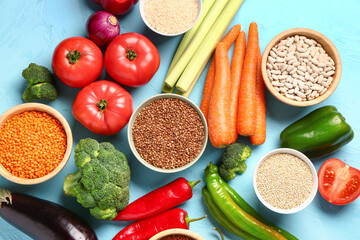 Different fresh vegetables and cereals on blue background
