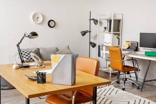 Workplace with folder and stationery in modern office