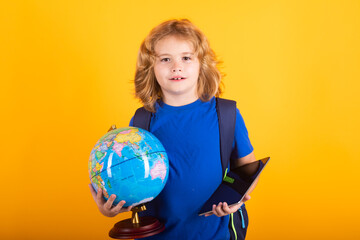 School boy world globe and tablet. School child 7-8 years old with book go back to school. Little student.
