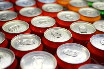 Cans of soft drink lined up ,