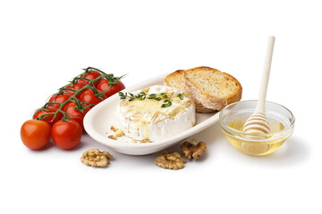 Plate of tasty baked Camembert cheese with tomatoes, honey and bread on white background
