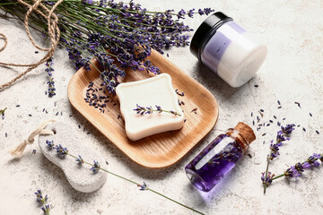 Composition with cosmetic products, pumice stone and lavender flowers on light background