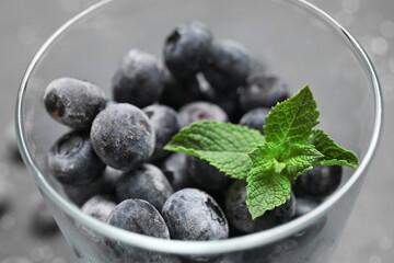 Glass of frozen blueberry with mint leaves, closeup