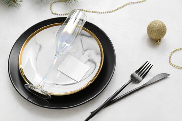 Beautiful table setting for Christmas celebration on light background
