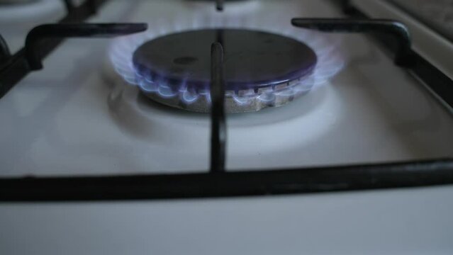Ignite the burner in the gas stove. Slow motion Dolly shot. Close-up