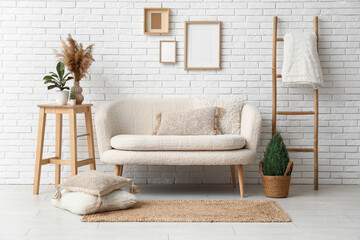 Interior of light living room with white sofa and wicker carpet
